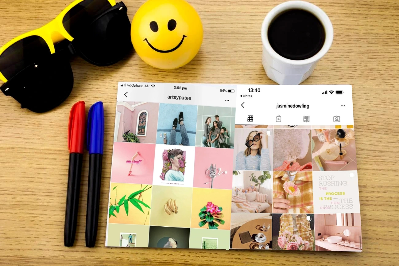 Sunglasses, three markers, a smiley face ball, a cup of coffee, and a tablet displaying two Instagram profiles on a wooden table—perfect inspiration for crafting creative IG captions.